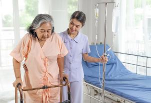 Caring nurse assisting patient