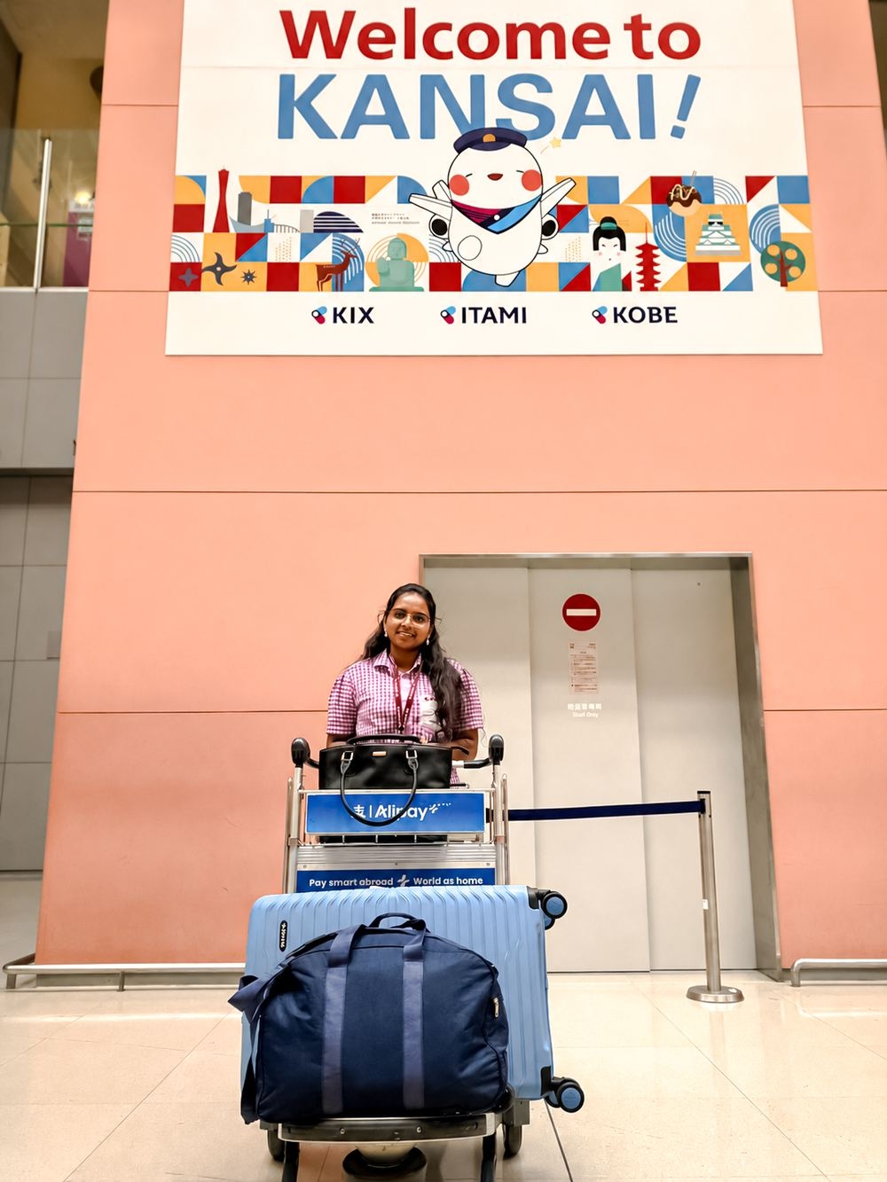 Indian nurse arriving in Japan at Kansai Airport with luggage